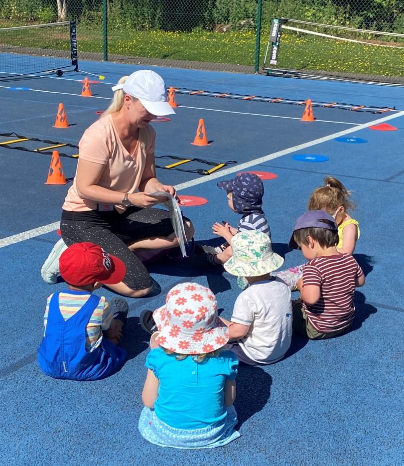 Tennis coach with small children